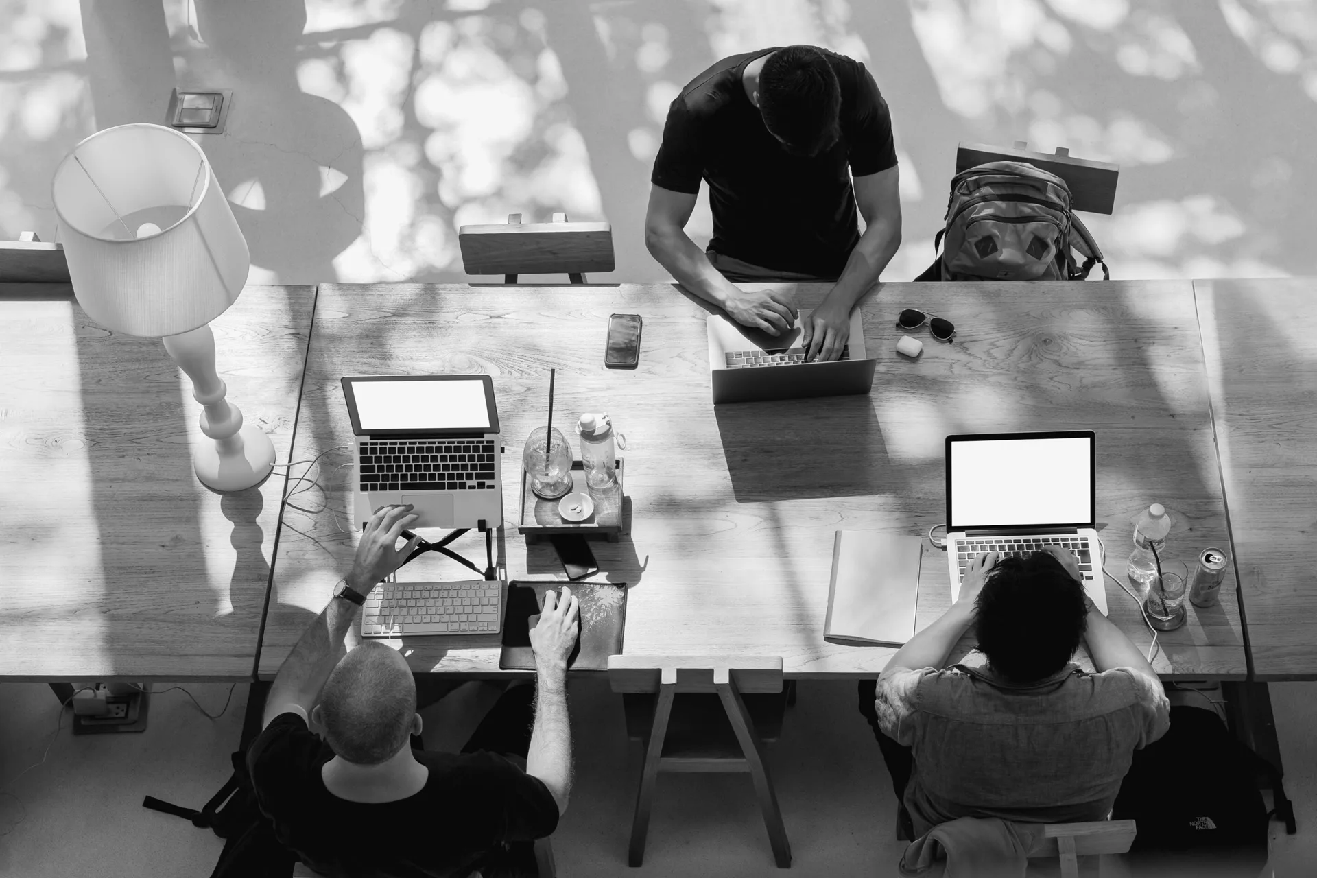Team working together at a communal table from above